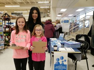 MPP Goldie Ghamari petitioned with future high school students Rachel, 10, and Chelsea, 6, at a Riverside South grocery store. (Photo © Jennifer Liu)