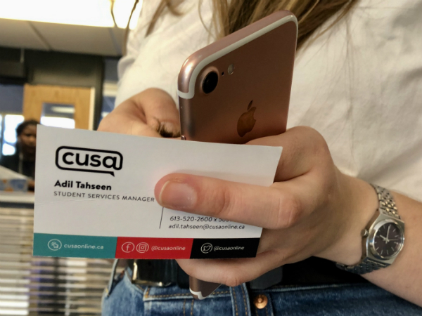 Woman holds business card