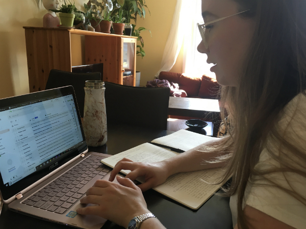 A woman types on a laptop.