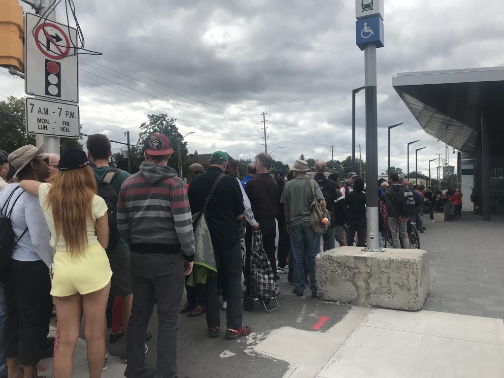 People lining up at Tuney's Pasture LRT Station