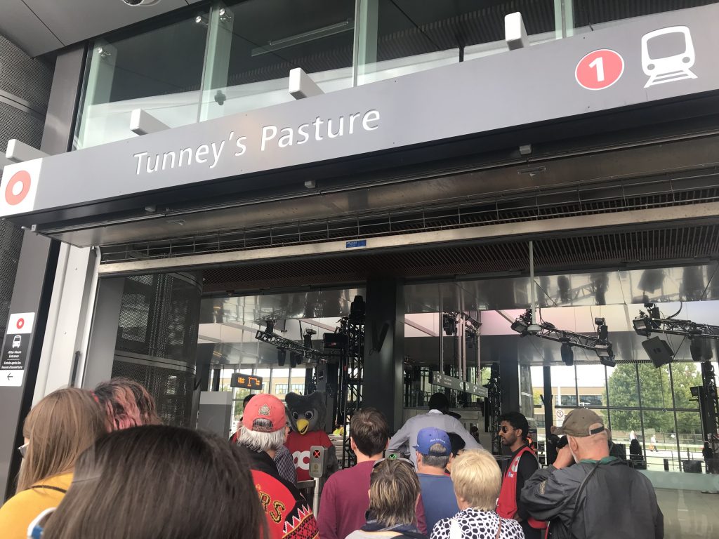 People lining up at the Tuney's Pasture LRT station