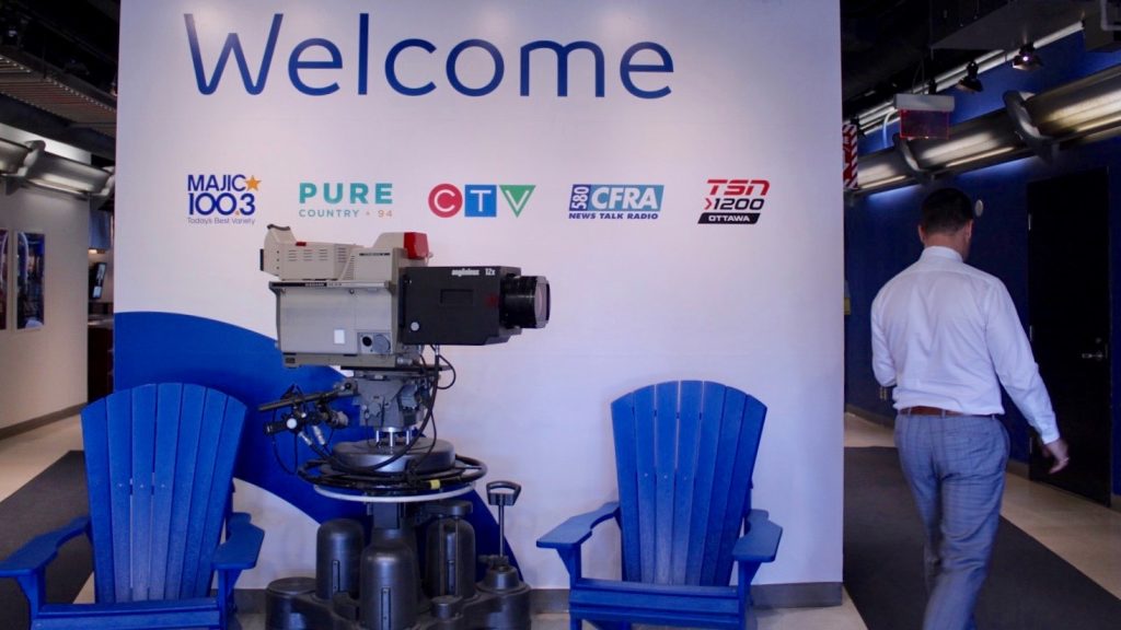 Matthew Skube walking past welcome sign in CTV Ottawa’s station. 
