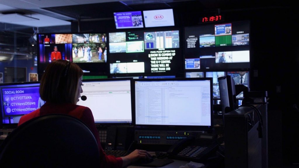 Skube’s producer in front of computer screens directing and monitoring the show. 
