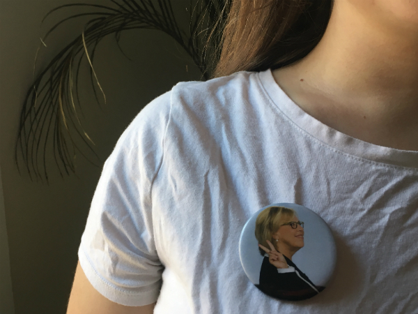 A woman wears a pin of Green Party leader, Elizabeth May.
