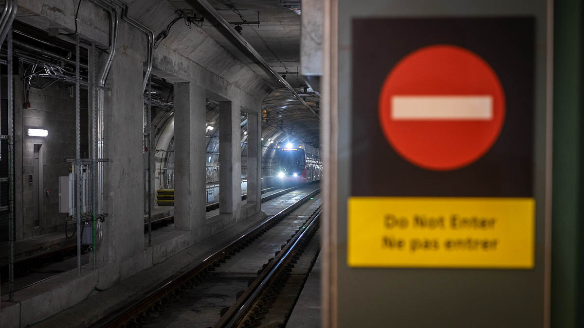 A train approaches a station in an Ottawa LRT tunnel.