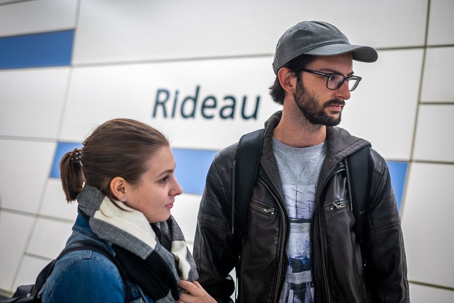 Clive Plante, standing next to a woman, looks out at someone talking off frame.