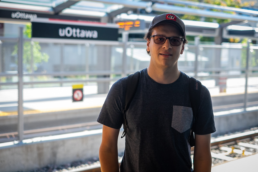 Patrick Lefebvre man smiles and poses at the uOttawa LRT stop.