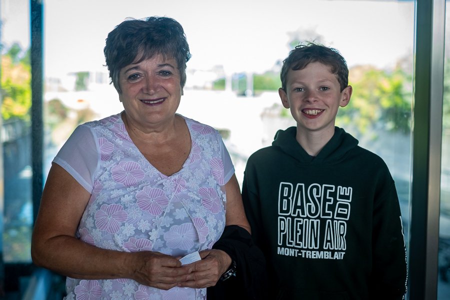 Cynthia Soucy and her grandson pose at an LRT station.