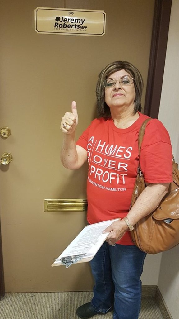 Activist Mavis Finnamore stands in front of MPP Jeremy Roberts office, holding the letter she will present to him.