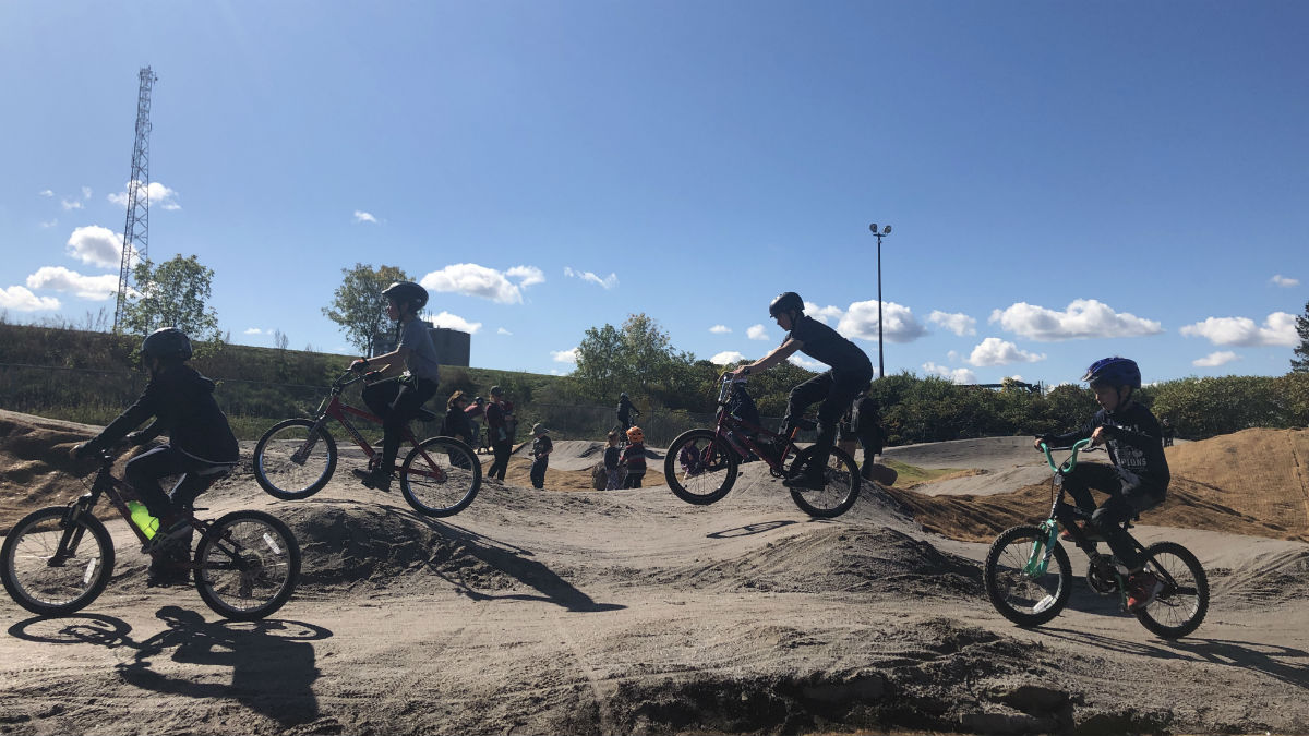 Kids enjoy the new bike park on opening day.