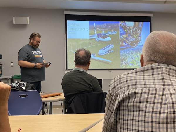 Mike Banks presents new developments in electric aviation through a powerpoint at the Canada Aviation and Space Museum.