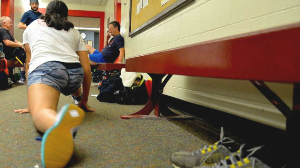 Athlete stretches with her foot towards the camera, lunging.