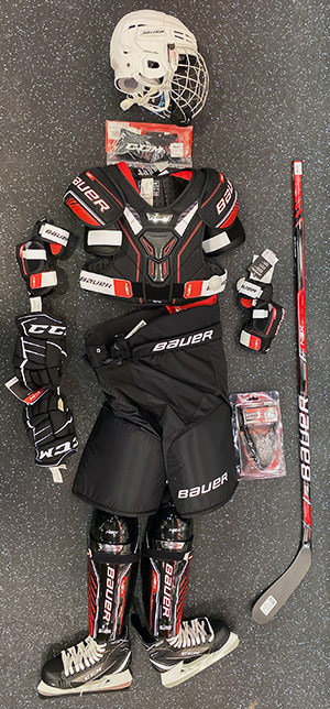 Hockey equipment sourced from SportsCheck. Includes: Helmet, neck guard, shoulder pads, elbow pads, gloves, pants, jock, shin guards, stick and skates. 