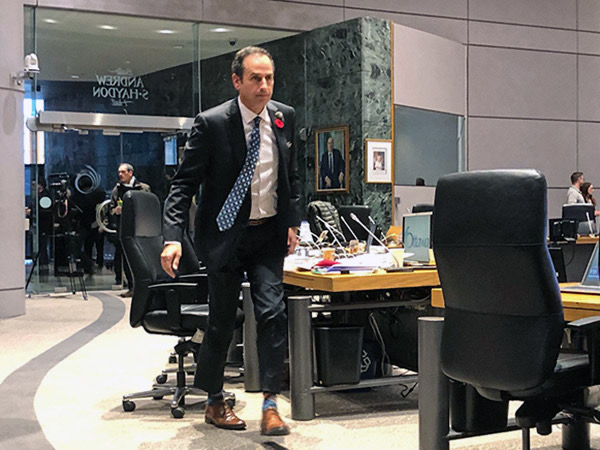 John Manconi at city hall walking away from his chair in preparation for the transit meeting. 