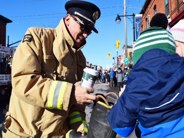 Firefighter accepts a toy donation.