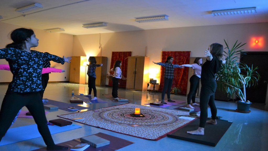 Kids practice a five-pointed star pose at a class a Surround Circle Yoga.