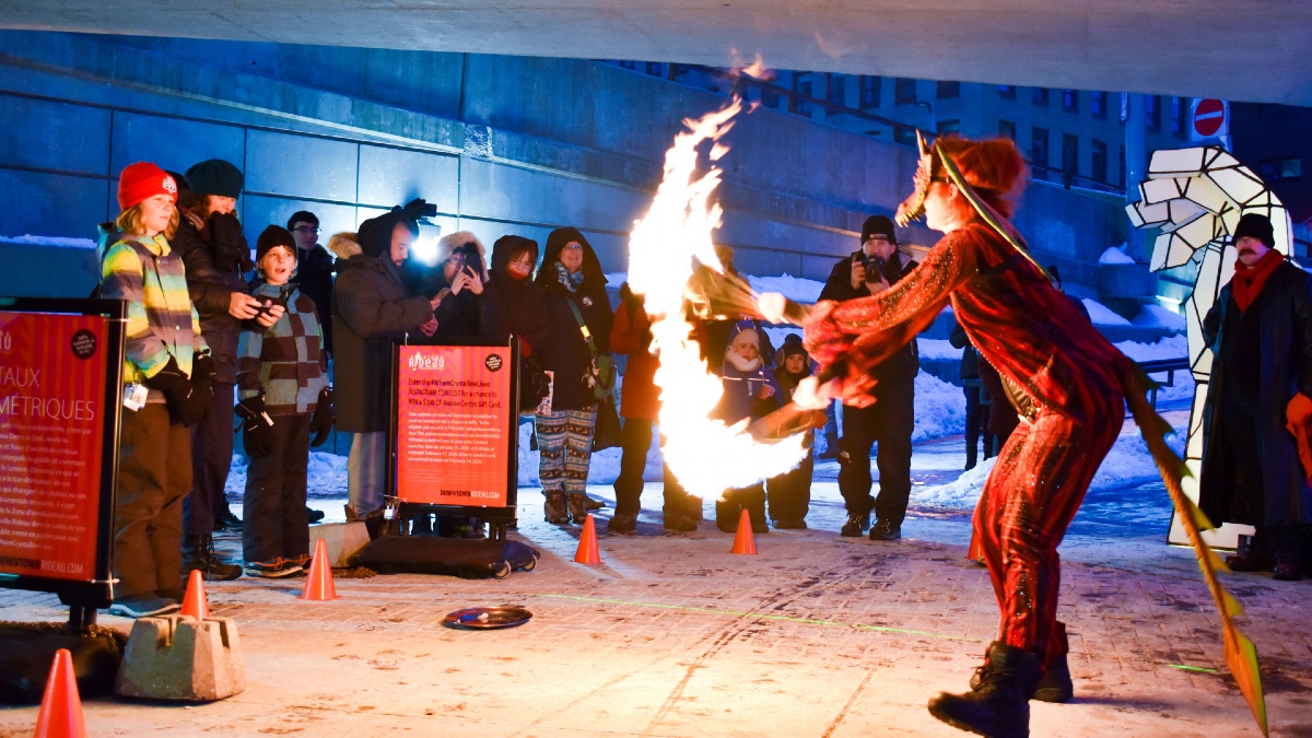 A fire dancer spins around their batons at the Rideau Underpass.
[Photo © Georgia Andromidas]