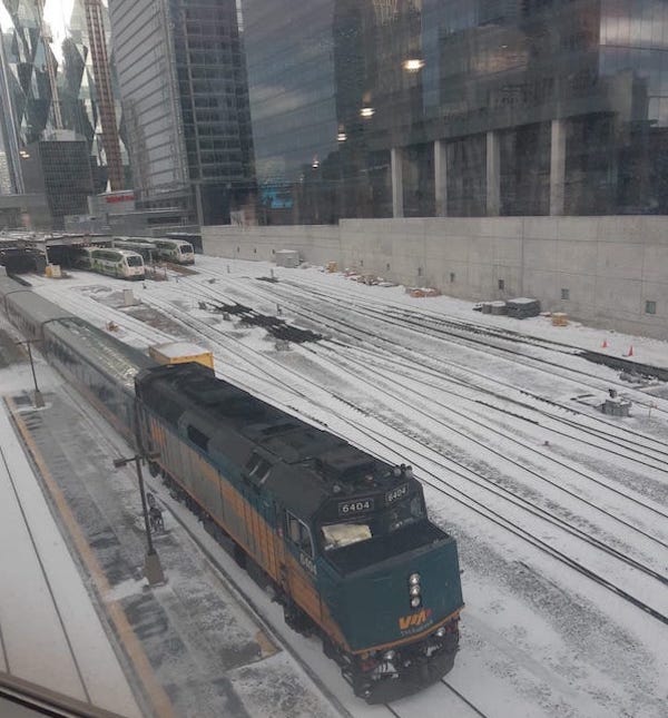 A via rail train leaving the station. 