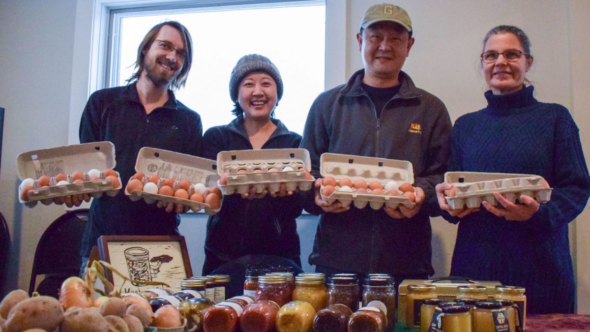 Four farmers stand side-by-side, holding their cartons of eggs. From left to right: Brett Weddle, Sun Shan, Li Bo and Denise Bonin-Mount. 