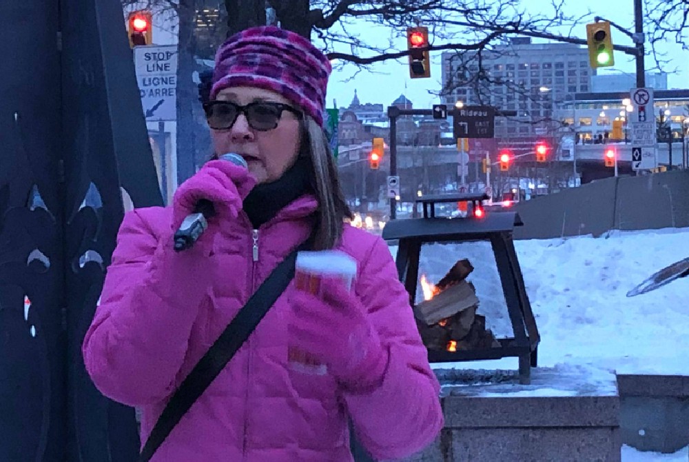 Peggy Ducharme, the executive director of the downtown business improvement association, addresses the crowd at Winterlude. 