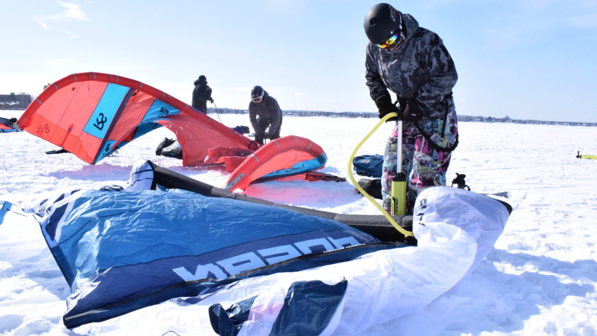 Campbell uses a manual pump to inflate his kite.