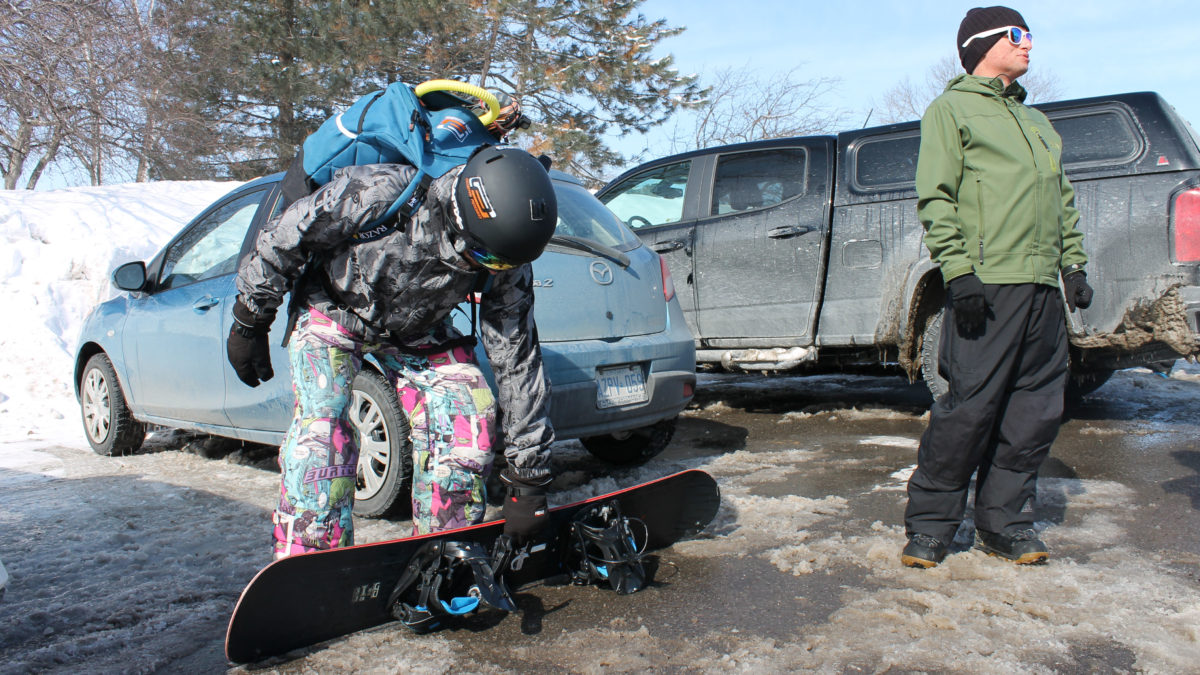 Campbell checks out his snowboard before heading out to Britannia Bay.