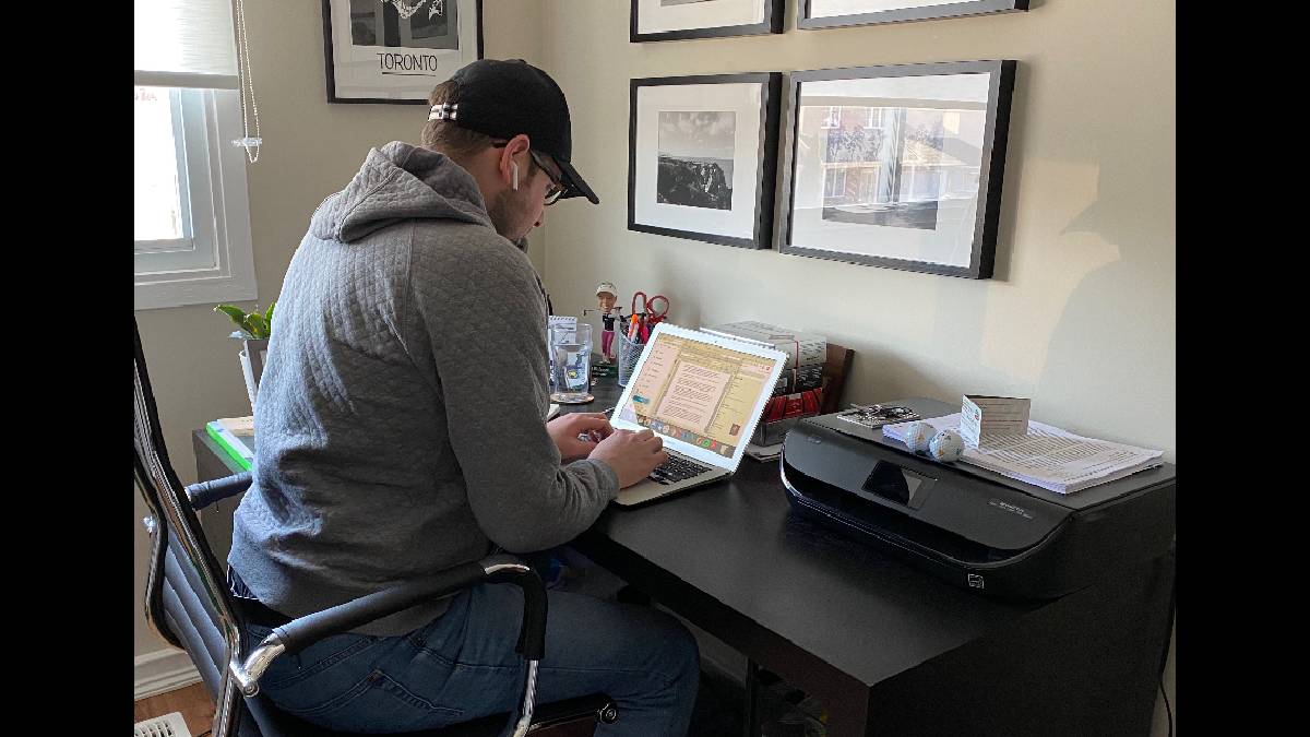 Journalist Adam Stanley works in his home office.