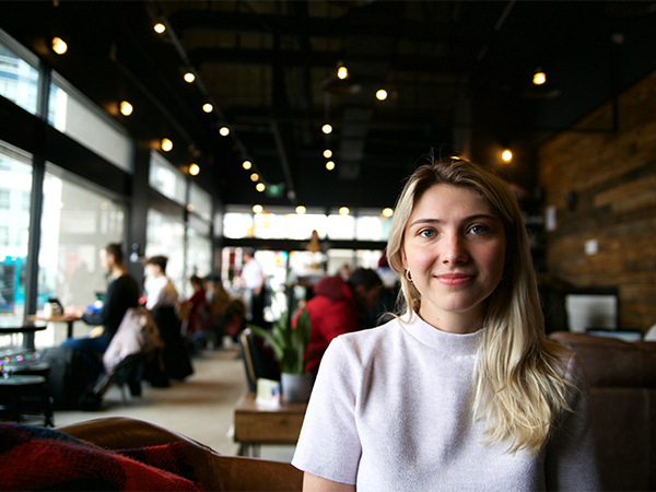 Liza Odokiienko sits in a cafe.