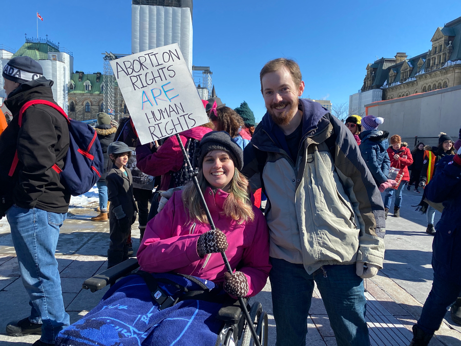 Participants of the Women's March holding a poster