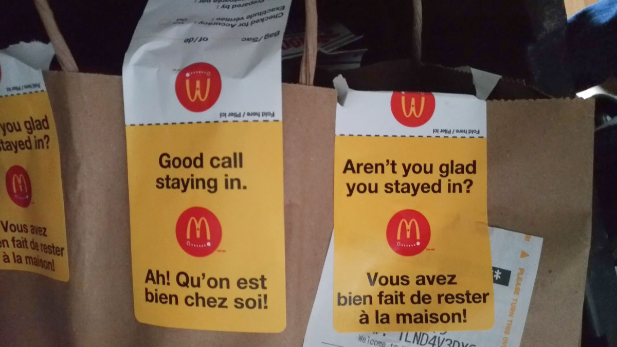 A paper bag with McDonald's UberEats stickers.