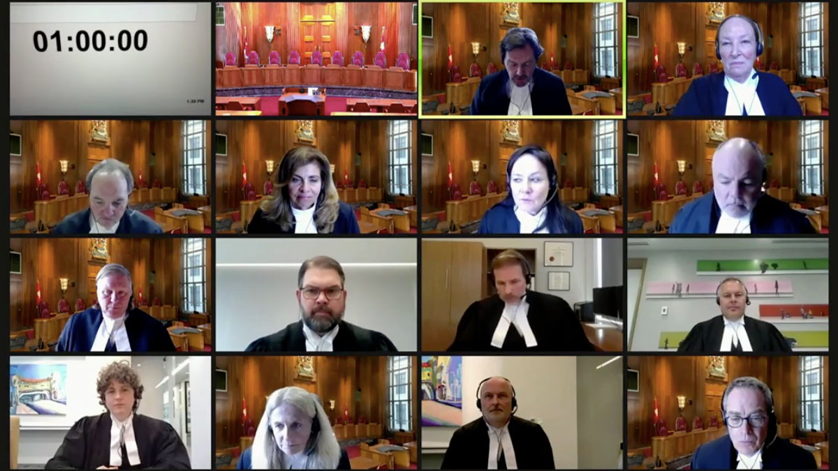 A laptop screenshot shows all judges and lawyers from the Supreme Court hearing