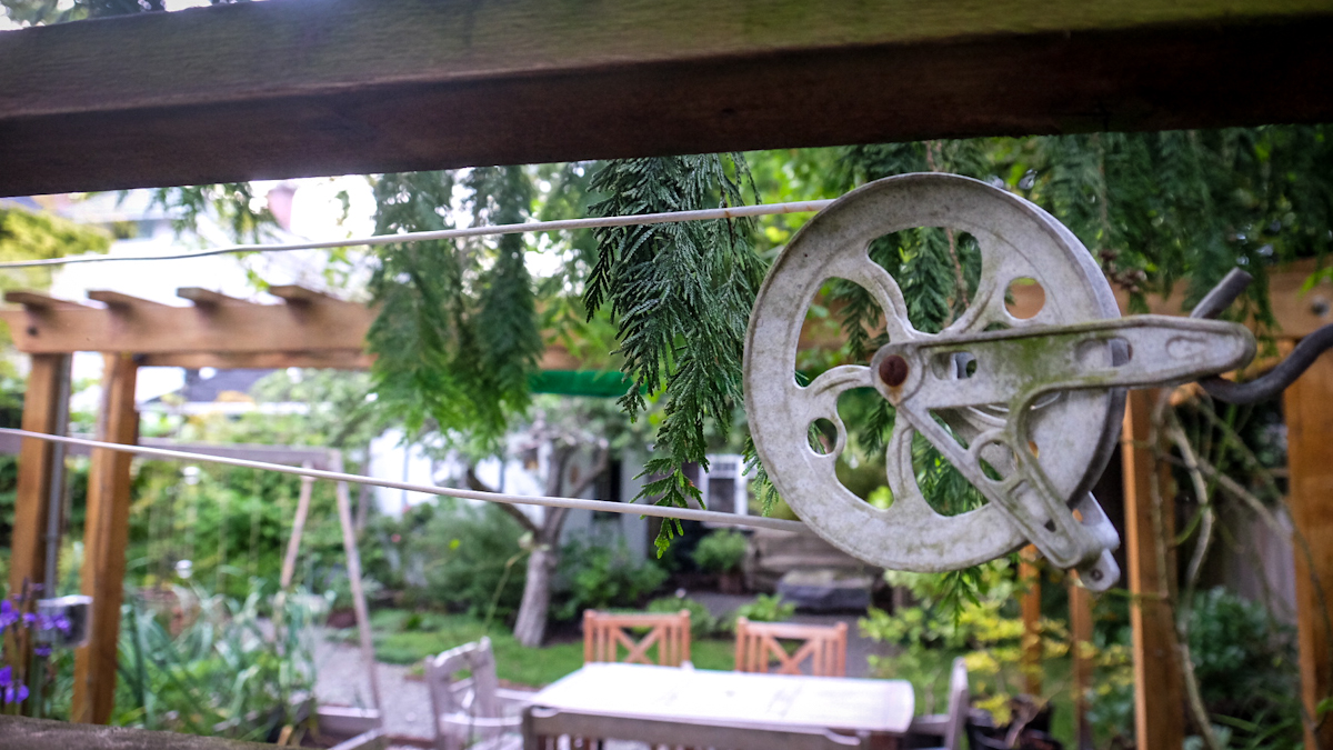 A clothesline reel posted in the backyard of a Victoria neighbourhood.