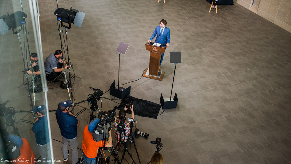 Prime Minister Justin Trudeau stands in front of the cameras to give his morning briefing