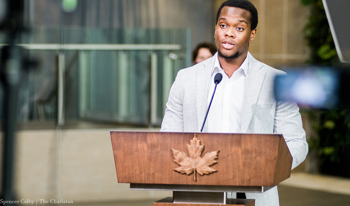 A student stands behind the podium to say his speech in French