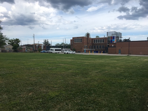 An empty field with a building in the background. 