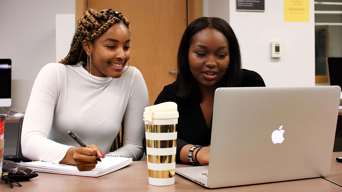 Two students working.