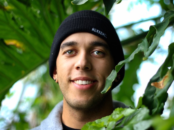 A photo of the author of the article standing in a greenhouse. 