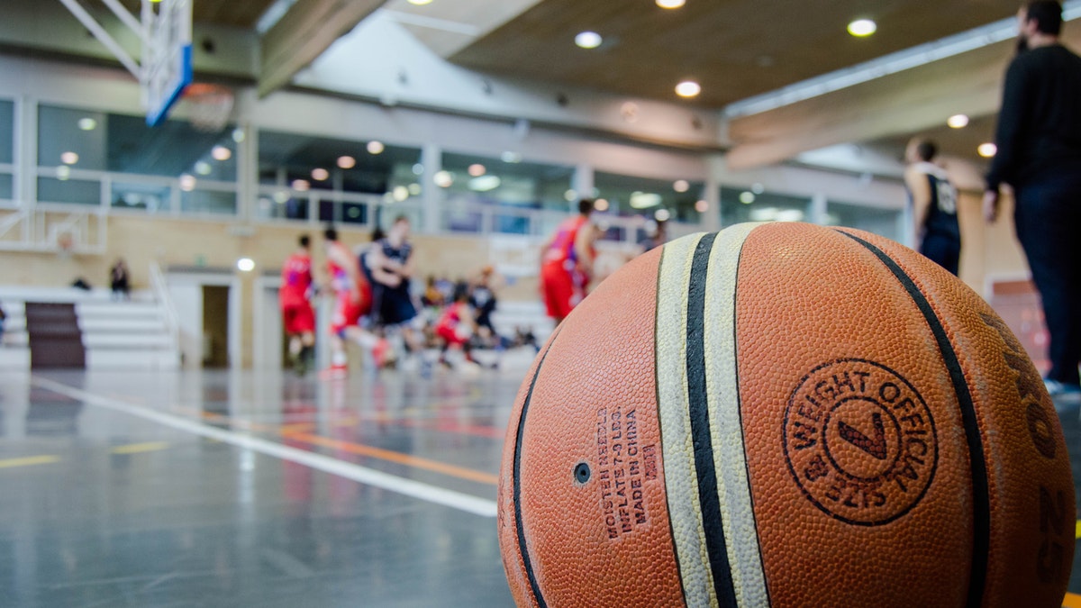 A picture of a basketball on the ground during a game.