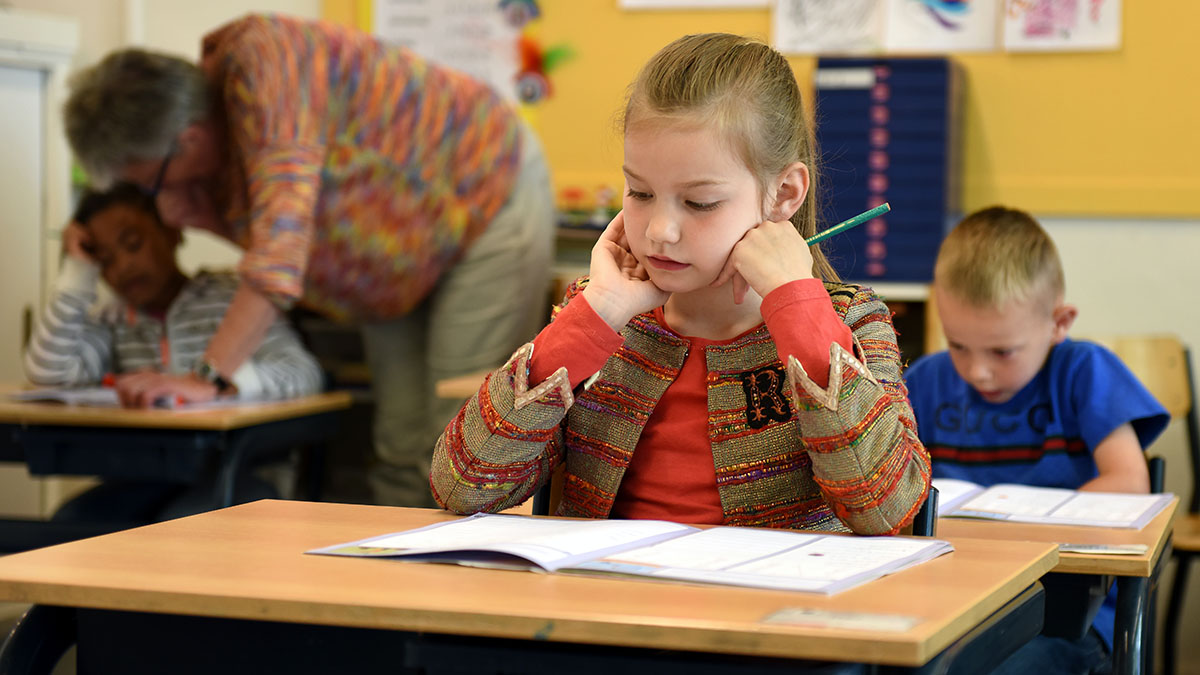 Students learning at their desks in a classroom