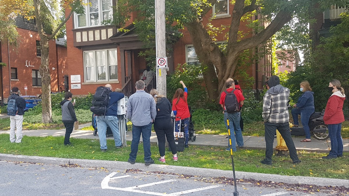 a dozen protesters gather outside of the smart living headquarters for a protest