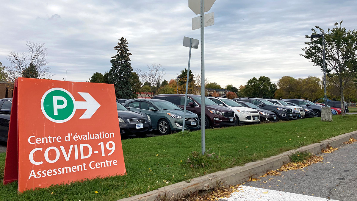 A sign displayed on the grass at Brewer Park directs drivers.