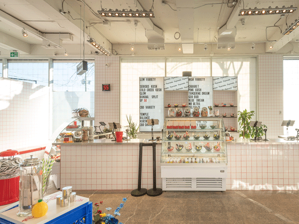 A local cannabis dispensary shows a display of their products like edibles, flowers and their own merchandise. 