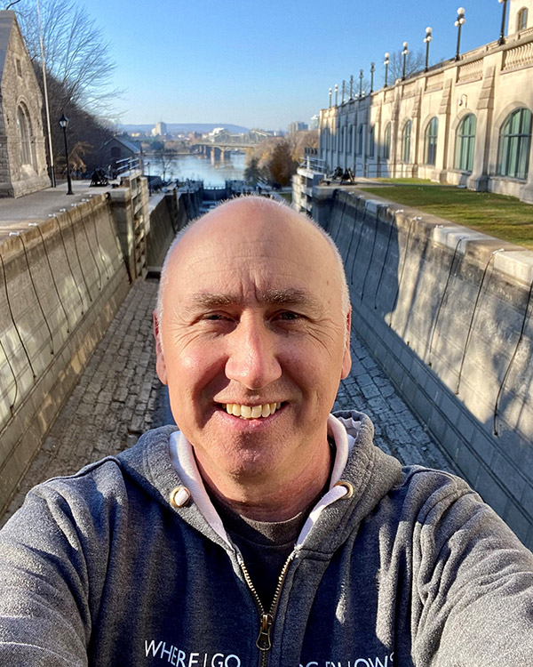 Kelvin Stanke smiles for a selfie by the Rideau Canal in Ottawa.