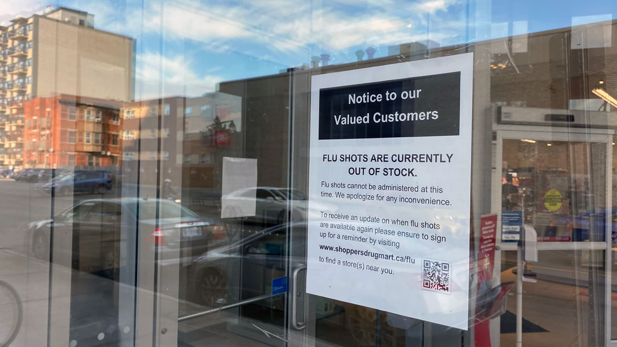 Photo of sign posted on Shoppers Drug Mart door reading: Notice to our Valued Customers, Flu Shots are Currently out of Stock. Flu shots cannot be administered at this time. We apologize for any inconvenience.