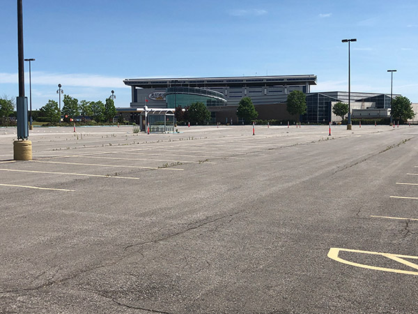 A large parking lot sits empty with the casino in the background.