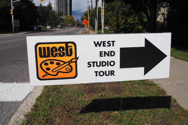 West End Studio Tour sign pointing towards studio on side of road.