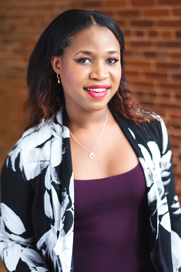 Headshot of Tatiana Ferguson in front of a brick wall 