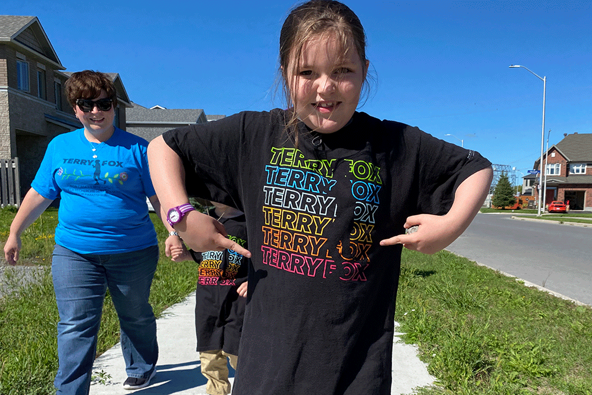 Emily Lingard, Lingard's daughter, pointing at her Terry Fox t-shirt.