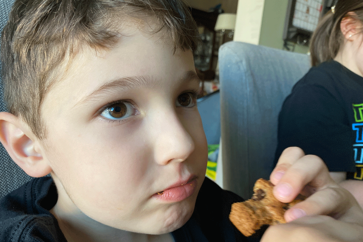 Danny Lingard eating a chocolate chip cookie.