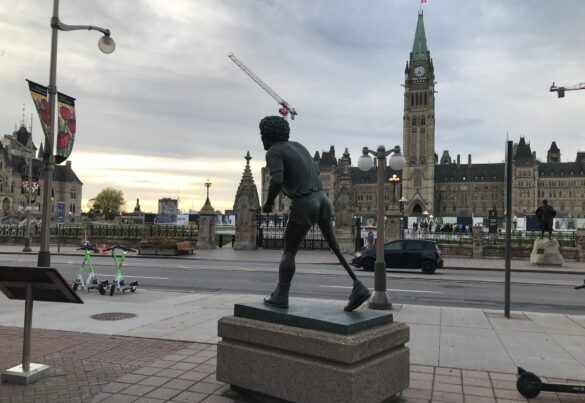 Image shows statue of Terry Fox with Parliament Buildings in background